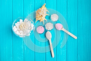 Sea Ã¢â¬â¹Ã¢â¬â¹salt in a glass white stones and Shell for spa and relaxation on a blue background